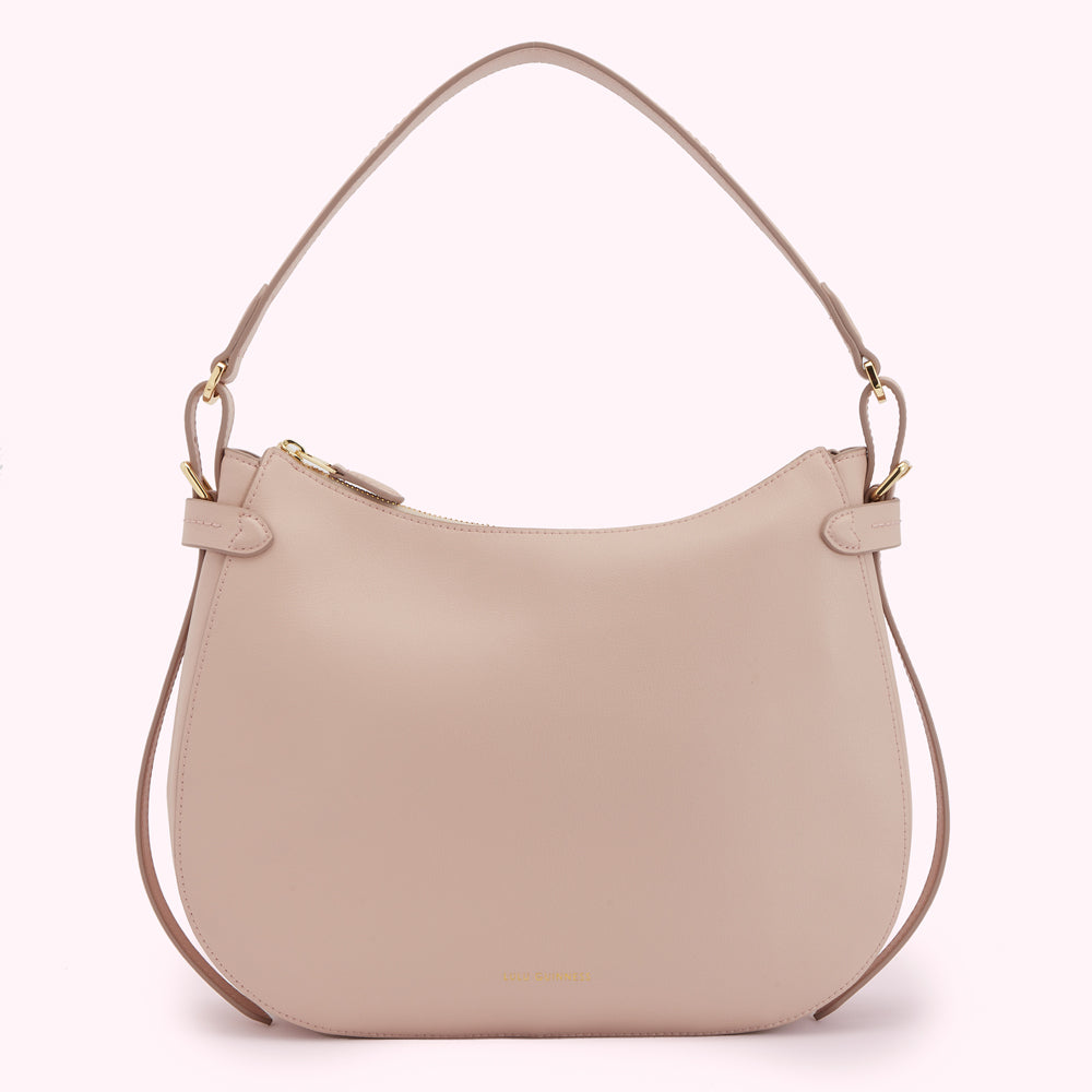 A light beige leather hobo bag with gold hardware.
