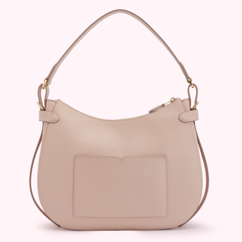A blush pink leather hobo bag with a smaller pocket on the back.