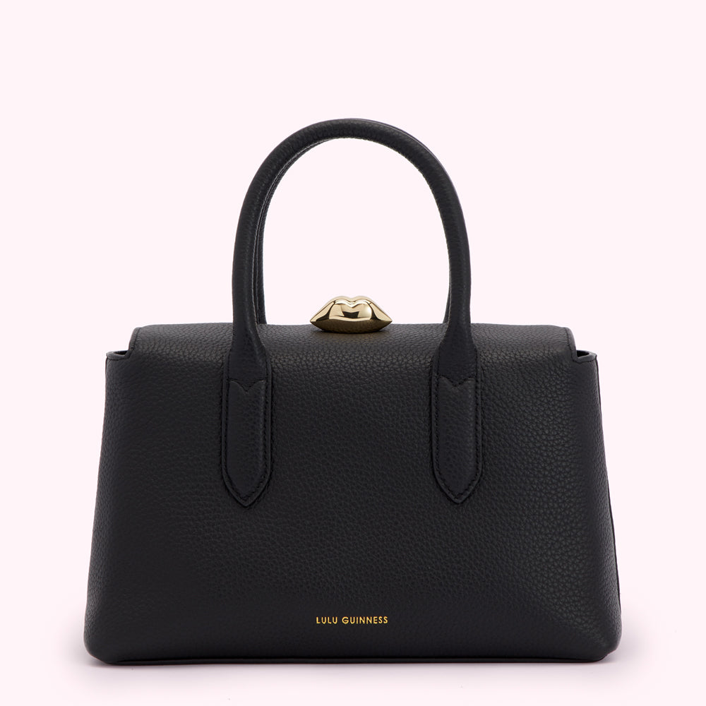 Black Lulu Guinness handbag with gold lip detail.
