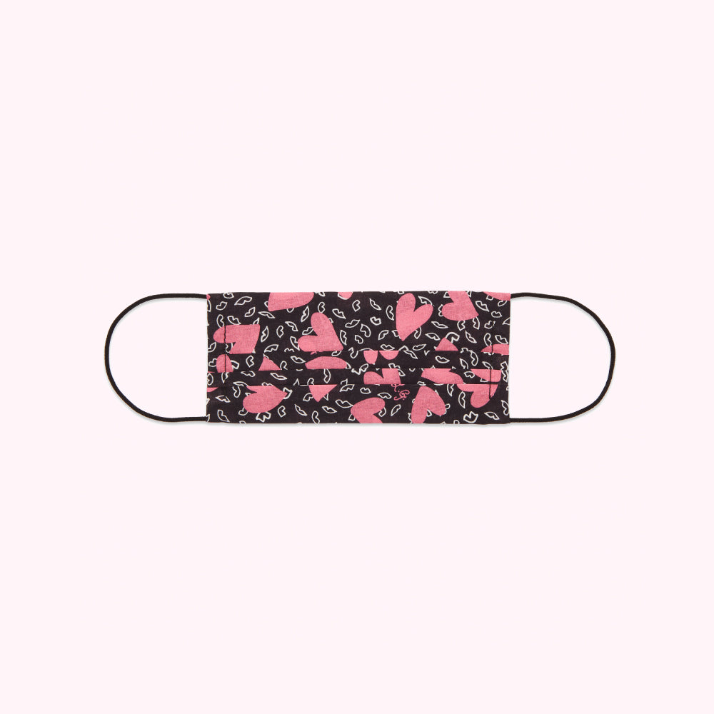 Black face mask with pink hearts and lips pattern.
