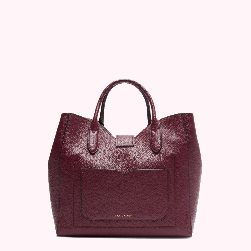 Burgundy leather tote bag with a small front pocket and gold Lili Guinness logo.
