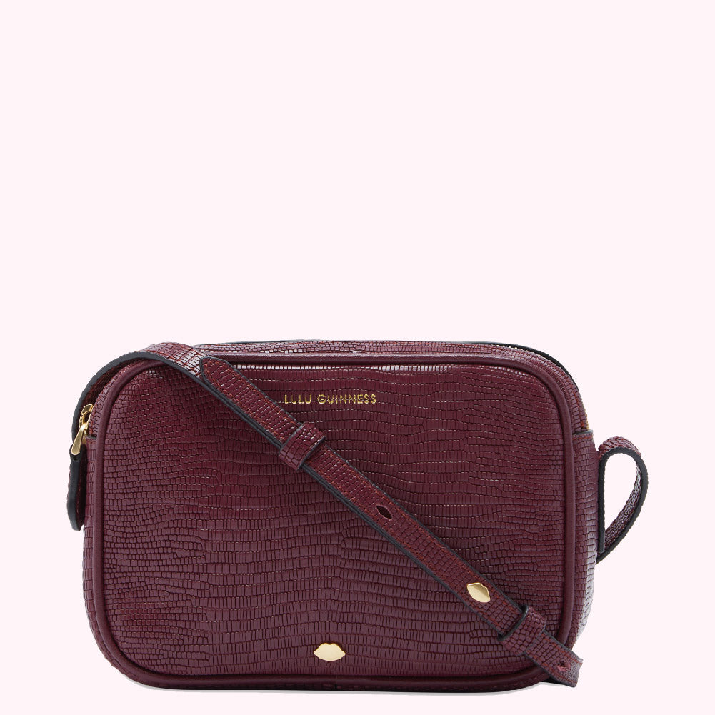 Burgundy Lulu Guinness crossbody bag with snakeskin texture.