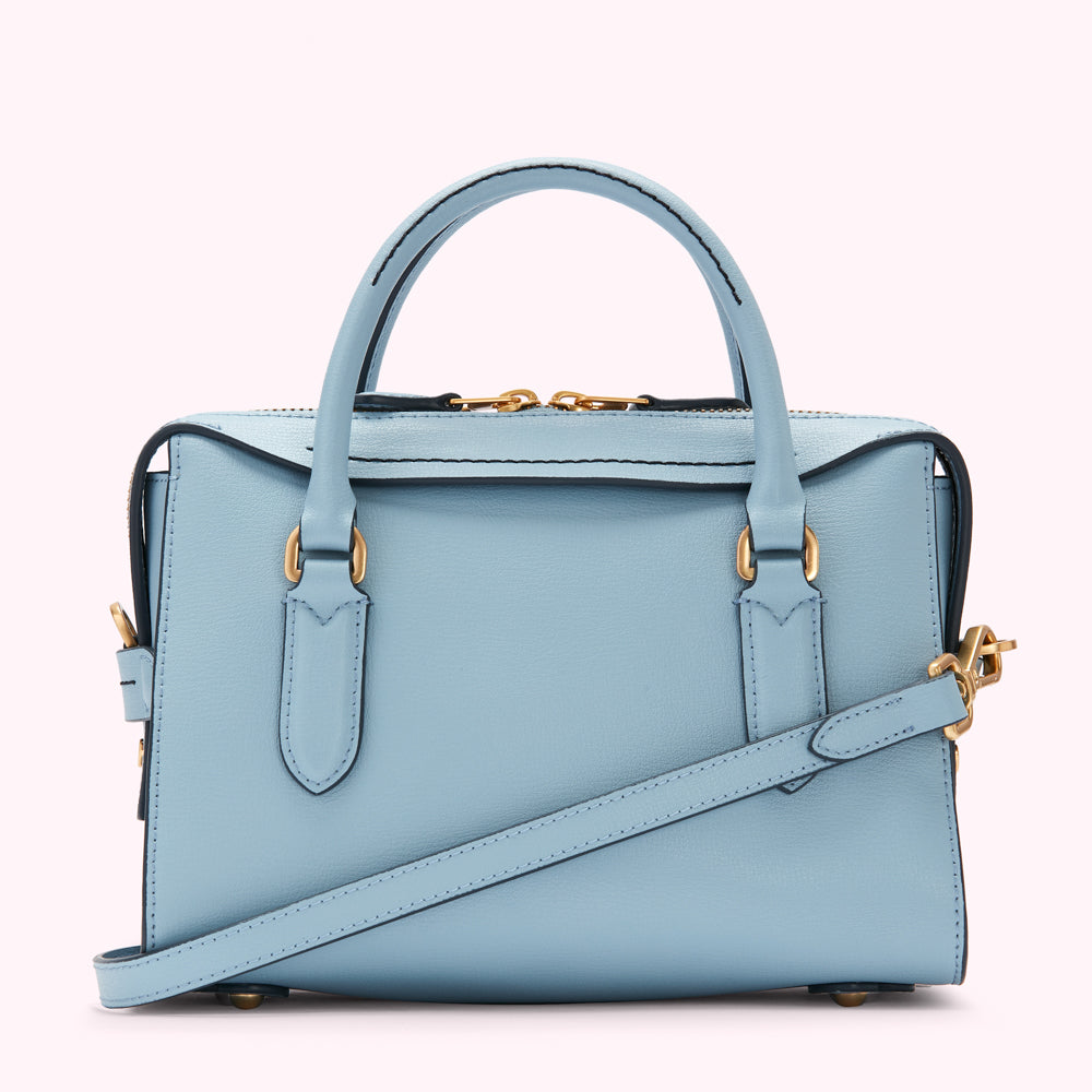 Light blue leather handbag with gold hardware and a detachable shoulder strap.
