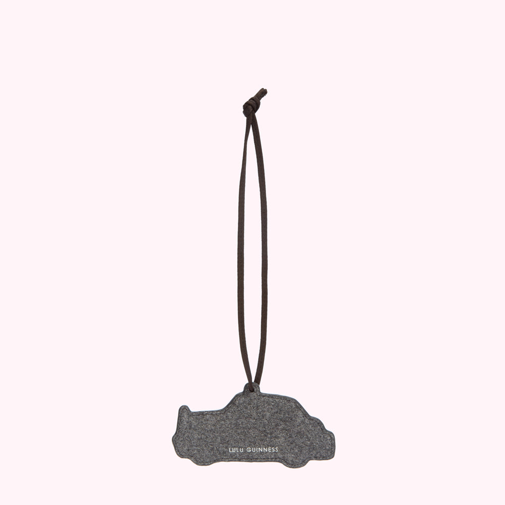 Grey felt car air freshener with brown cord hanging from a white background.