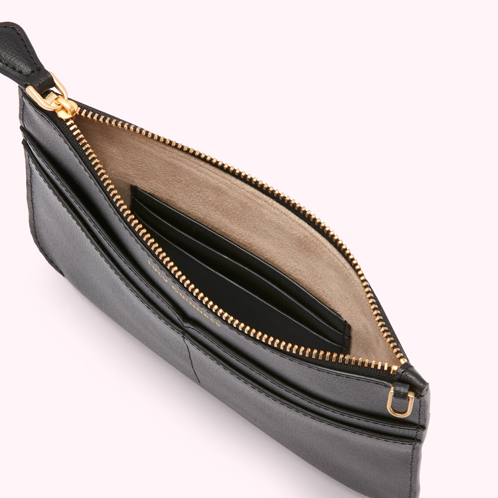 Open black leather zip pouch with multiple card slots and beige lining.

