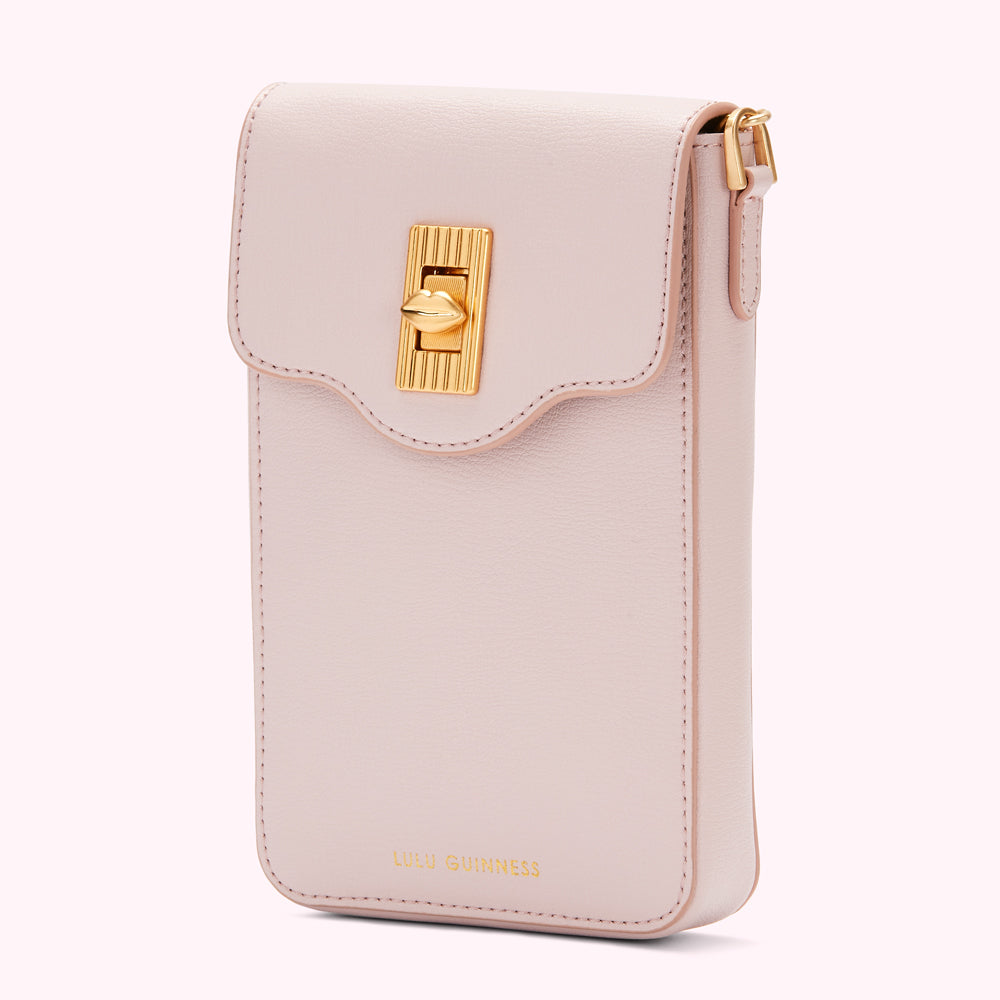 Pale pink Lulu Guinness crossbody phone bag with gold clasp.
