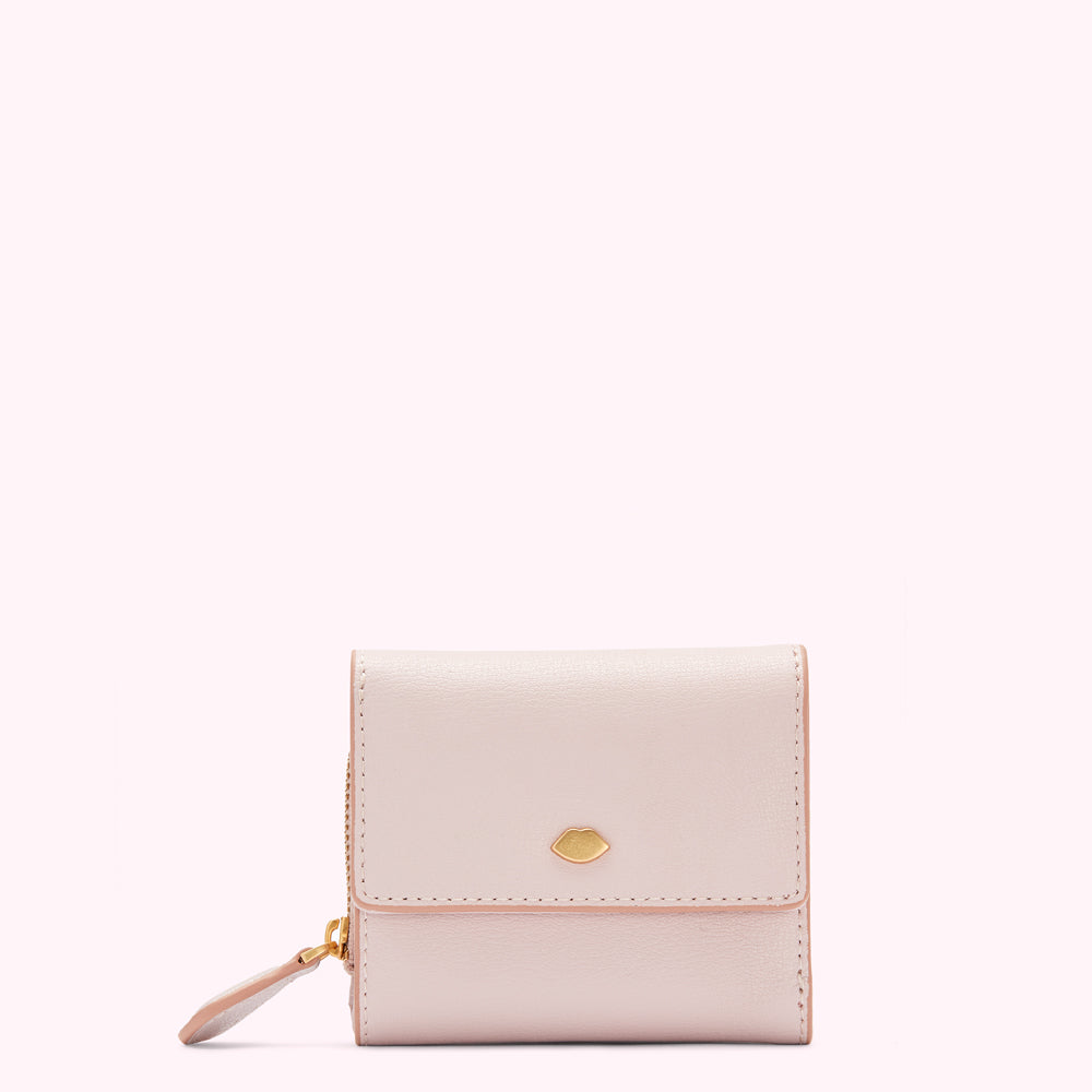 A pale pink leather wallet with a gold lip-shaped emblem.
