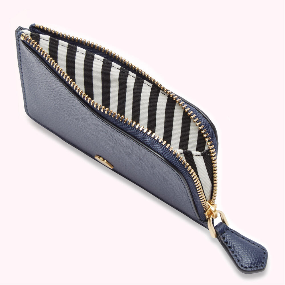 Navy blue zip-around cardholder with black and white striped interior.
