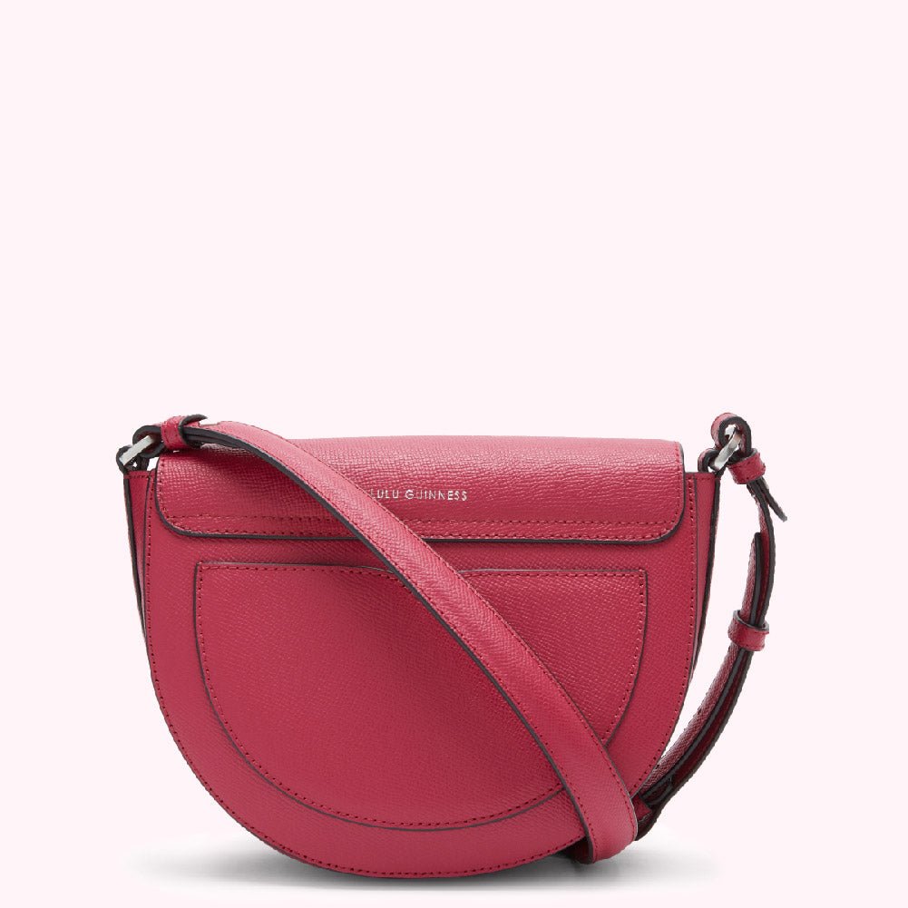 Pink Lulu Guinness half-moon crossbody bag.
