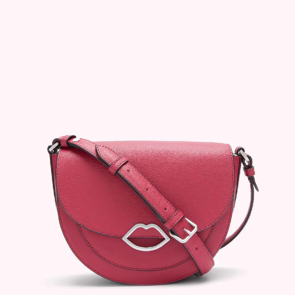 Pink half-moon crossbody bag with a silver lip-shaped clasp.
