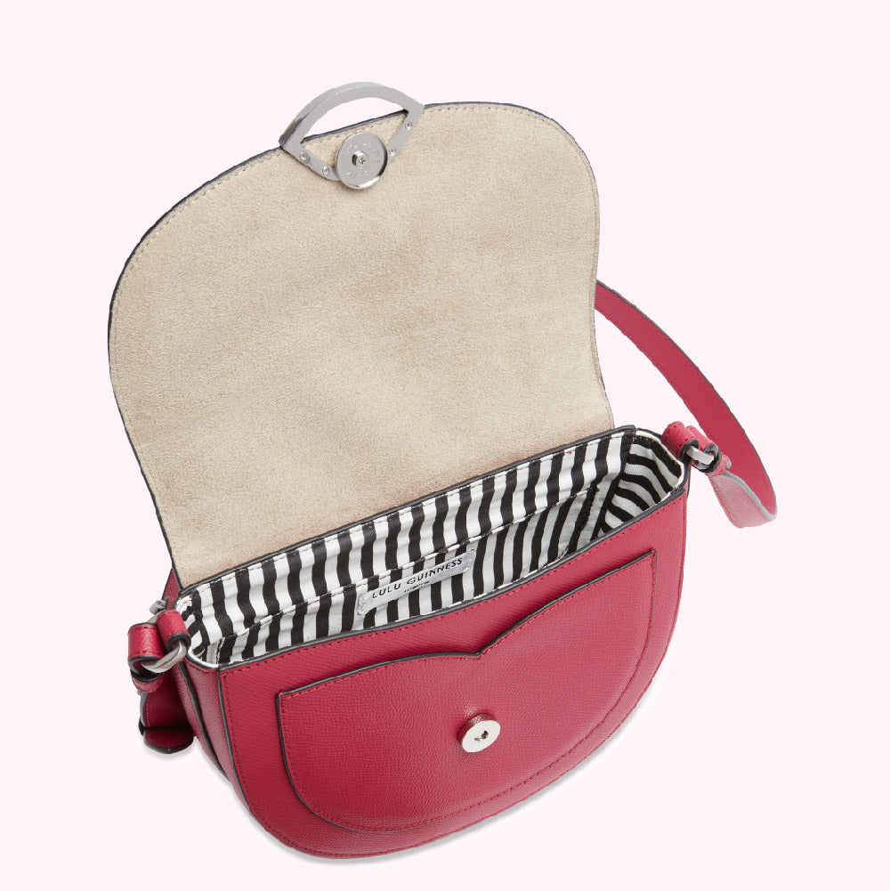 Crimson Lulu Guinness crossbody bag with beige interior and black and white striped lining, shown open.
