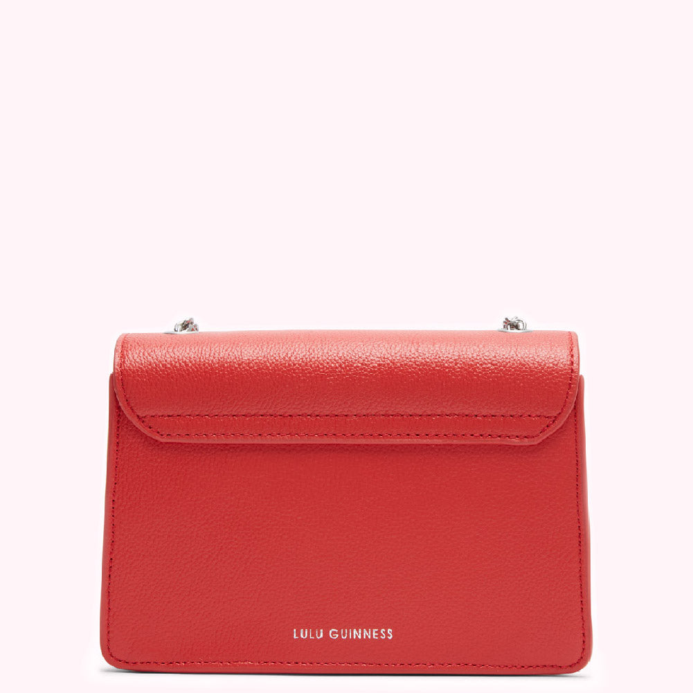 Red Lulu Guinness crossbody bag, back view.
