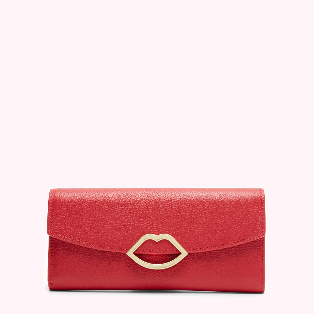 Red leather wallet with gold lip-shaped clasp against a white background.

