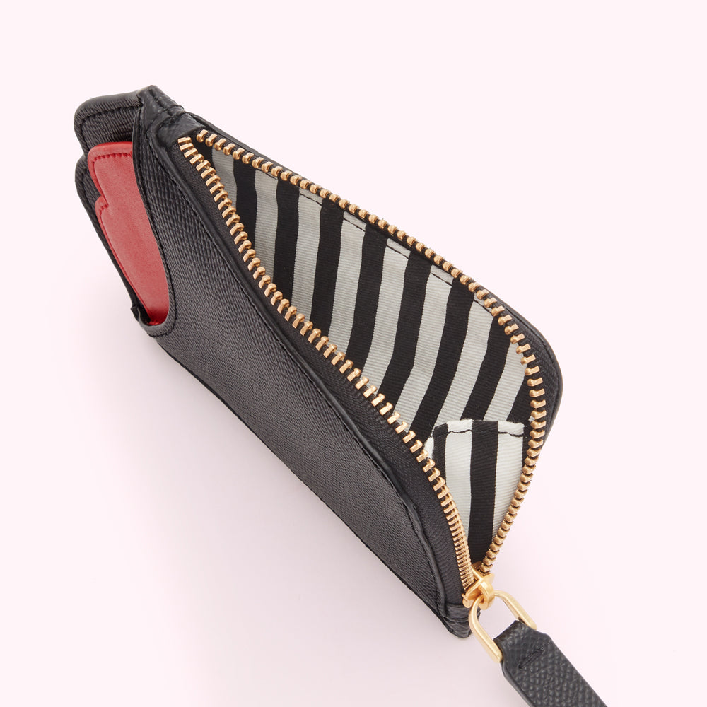 Black leather zip-around wallet with black and white striped interior, partially open to reveal red lining.
