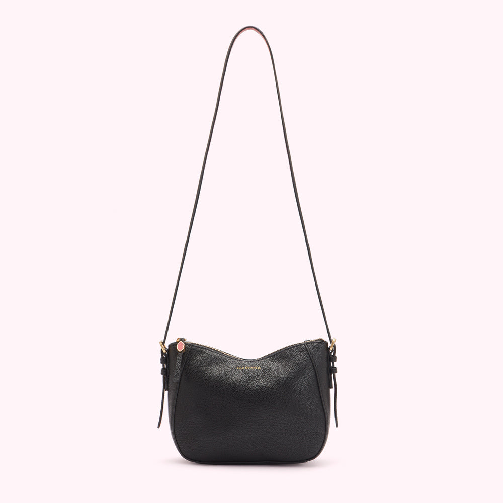 Black leather crossbody bag with a long strap against a white background.
