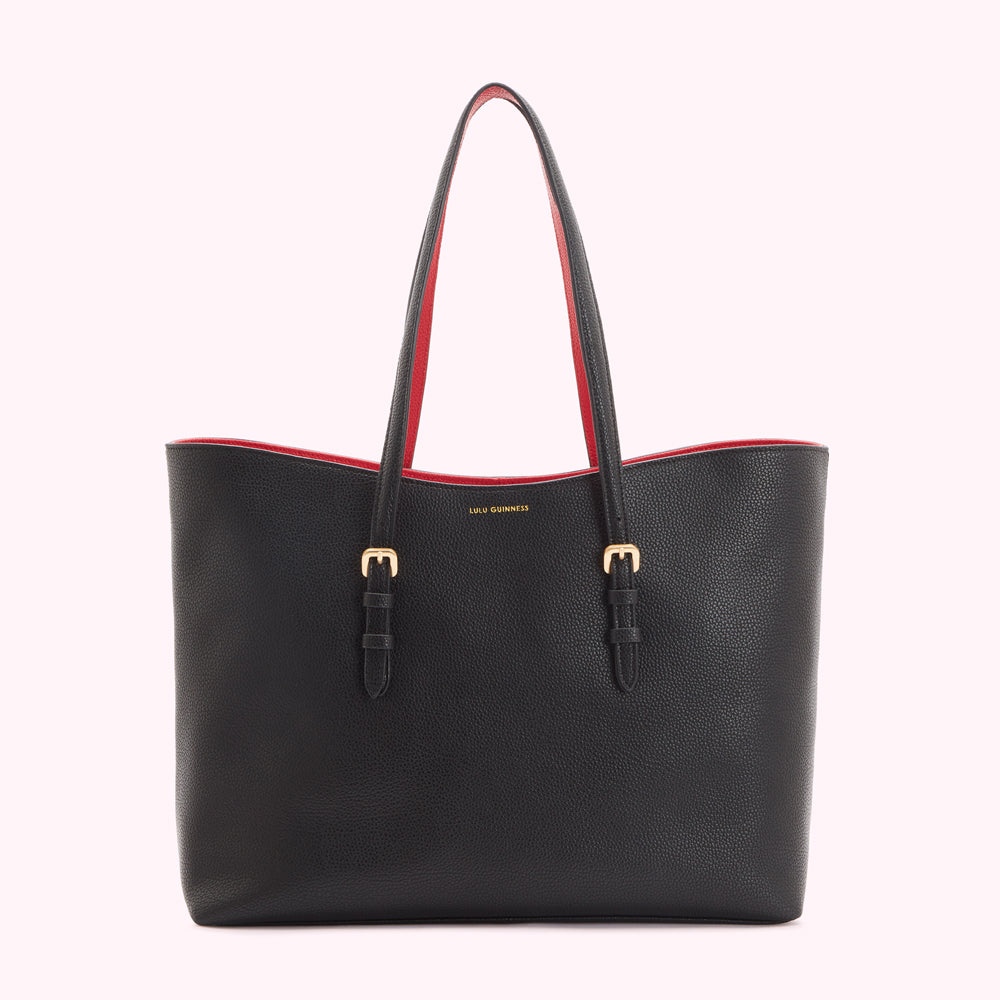 Black Lulu Guinness tote bag with red interior and gold buckles.
