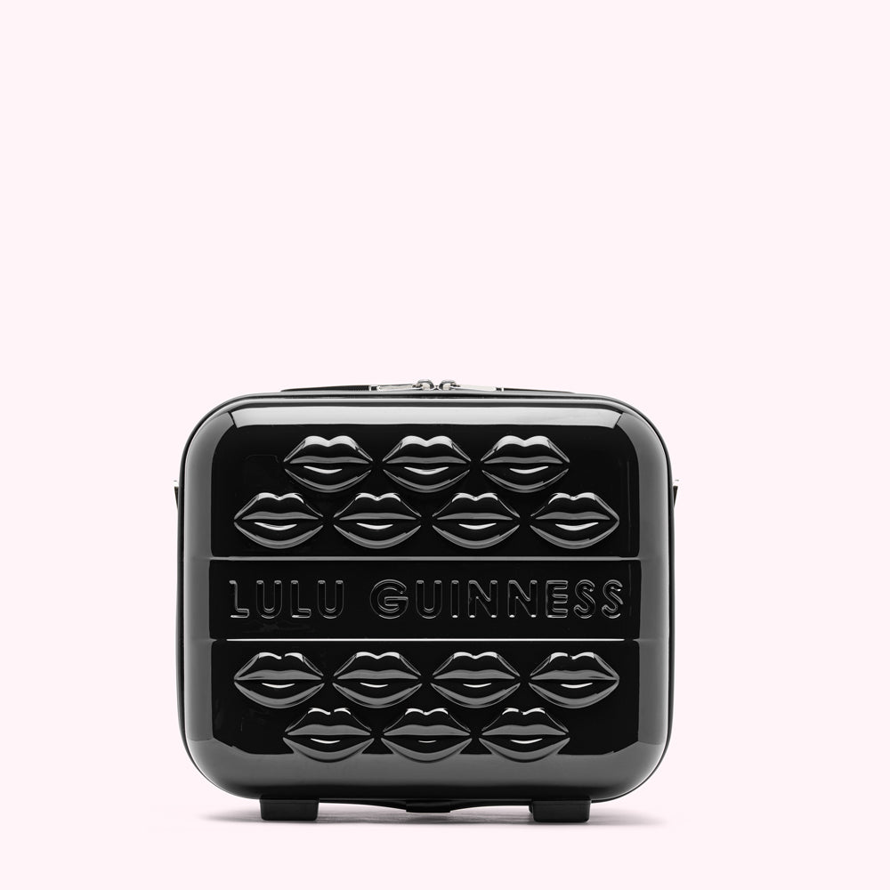 Black Lulu Guinness makeup case decorated with embossed lips.