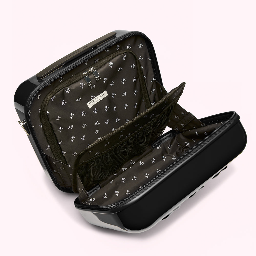 Open black Lulu Guinness carry-on suitcase with black interior featuring a repeating logo pattern.
