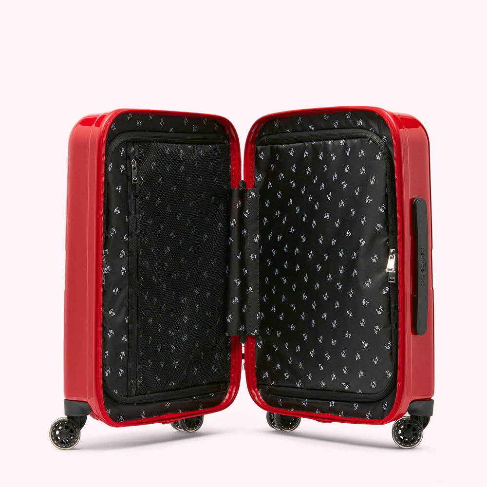 Open red suitcase with black interior lining featuring a repeating pattern.