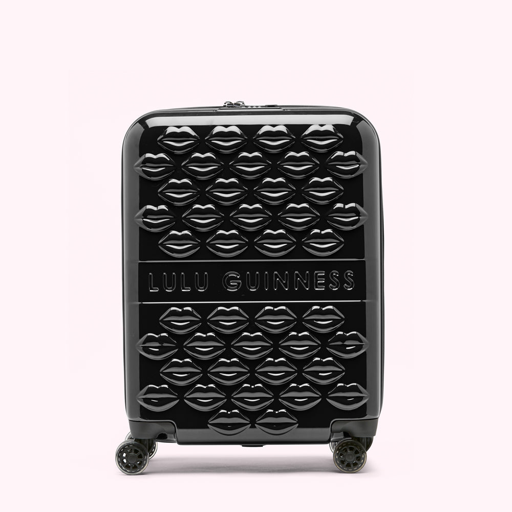Black Lulu Guinness suitcase covered in a pattern of glossy lips.