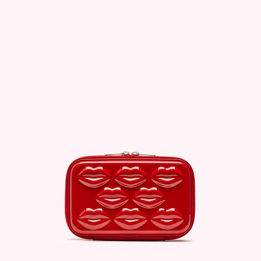 Red rectangular cosmetic case with embossed lips.
