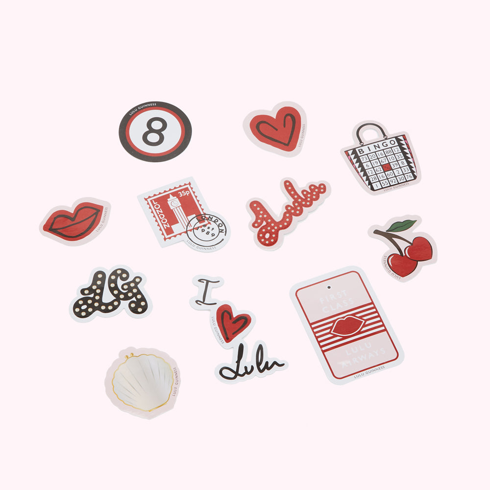 A collection of stickers featuring various designs, including numbers, hearts, lips, a bingo card, cherries, and the Lulu Guinness logo, on a white background.
