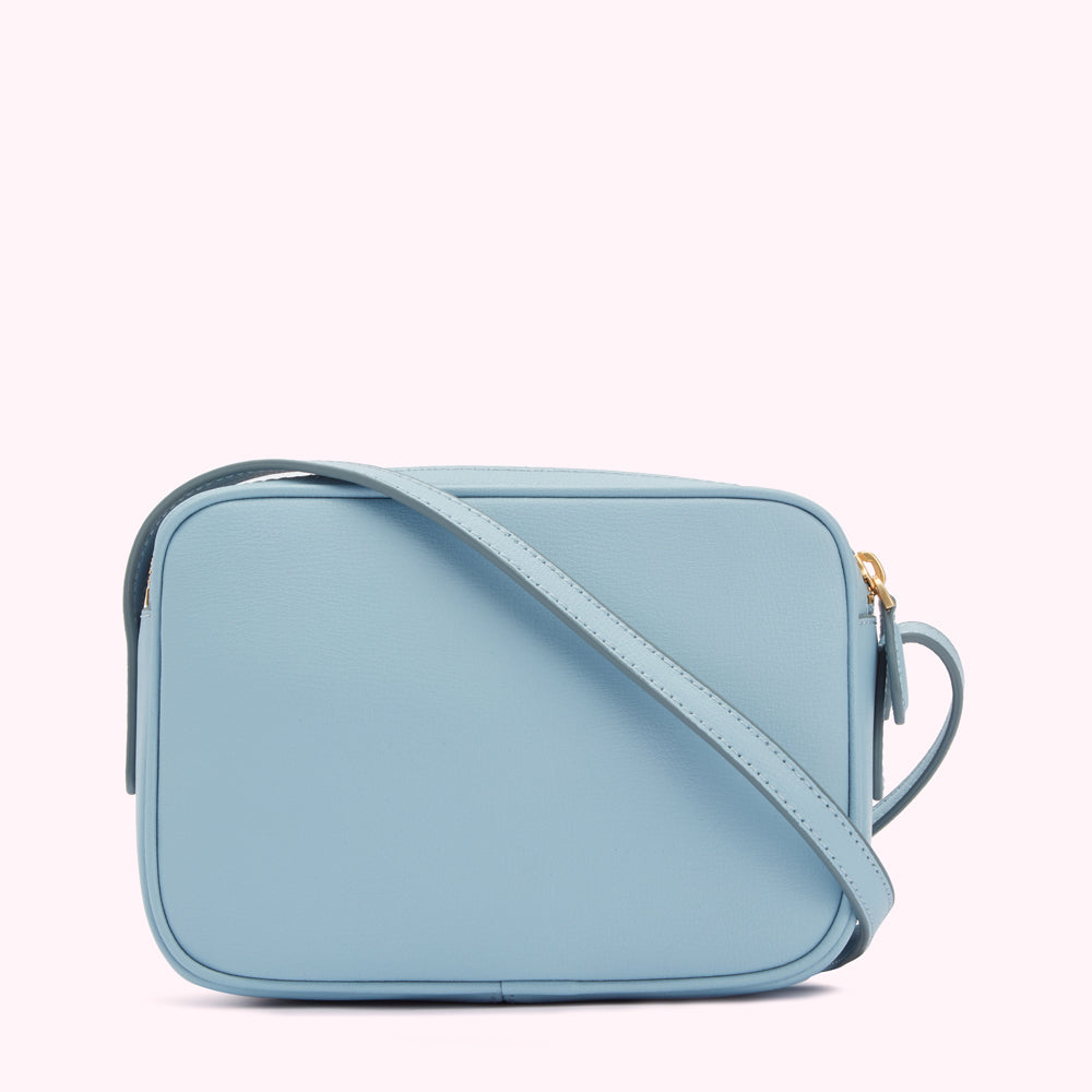 Light blue leather crossbody bag with gold hardware.
