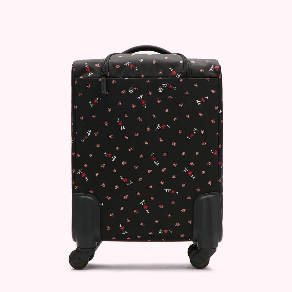 Black carry-on suitcase with a repeating pattern of red lips and "I love Lulu" text on a black background.
