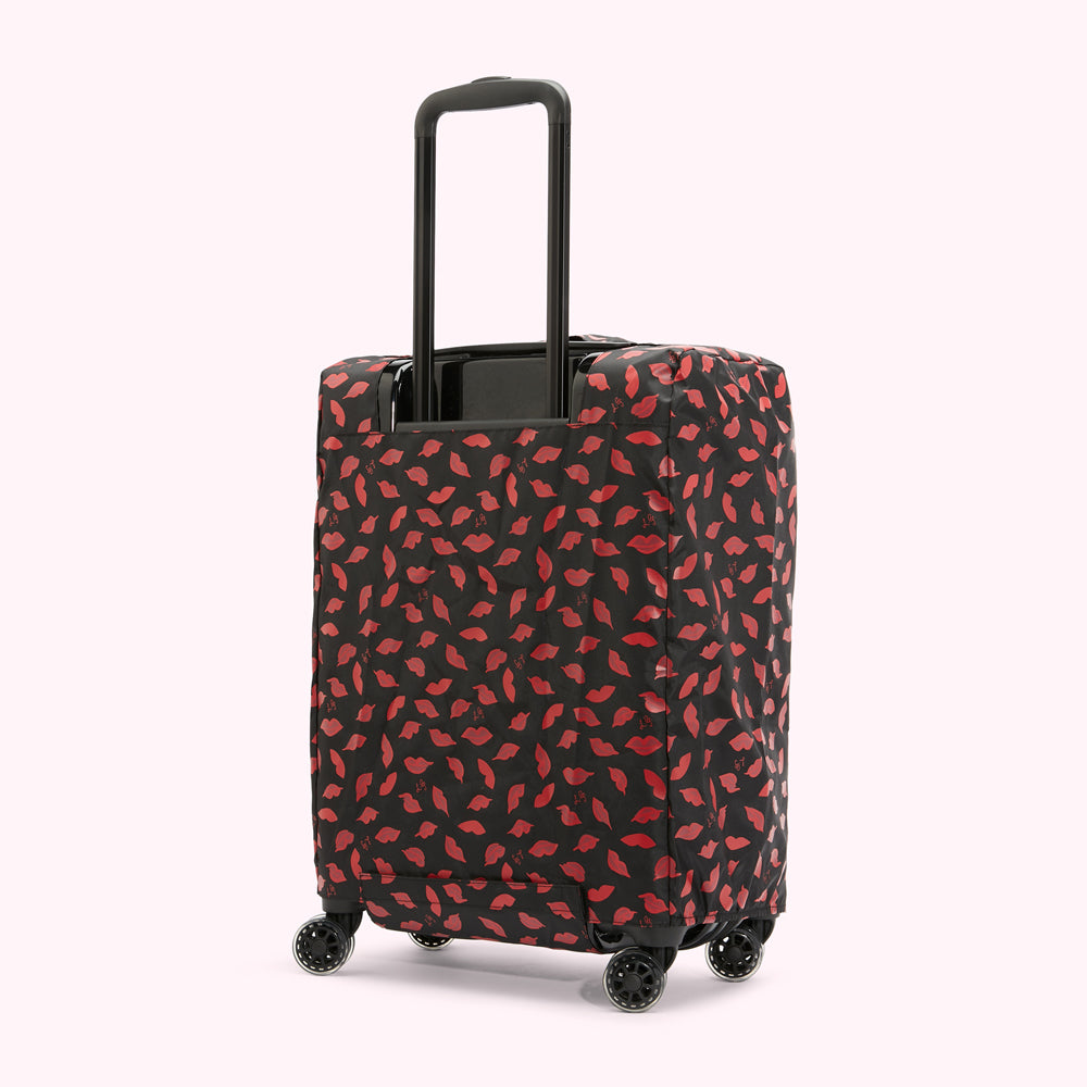 Black suitcase with a red lips pattern luggage cover.