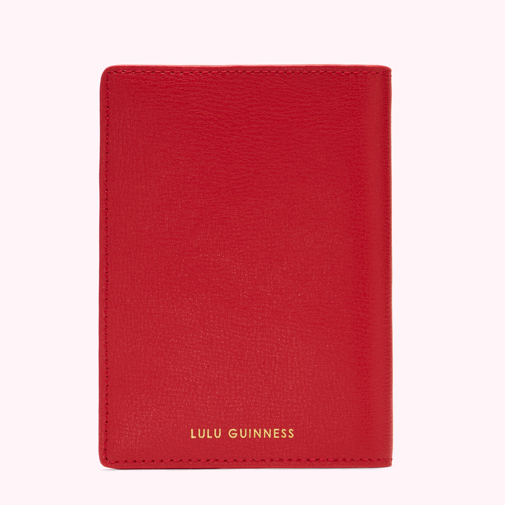 Red Lulu Guinness passport holder.
