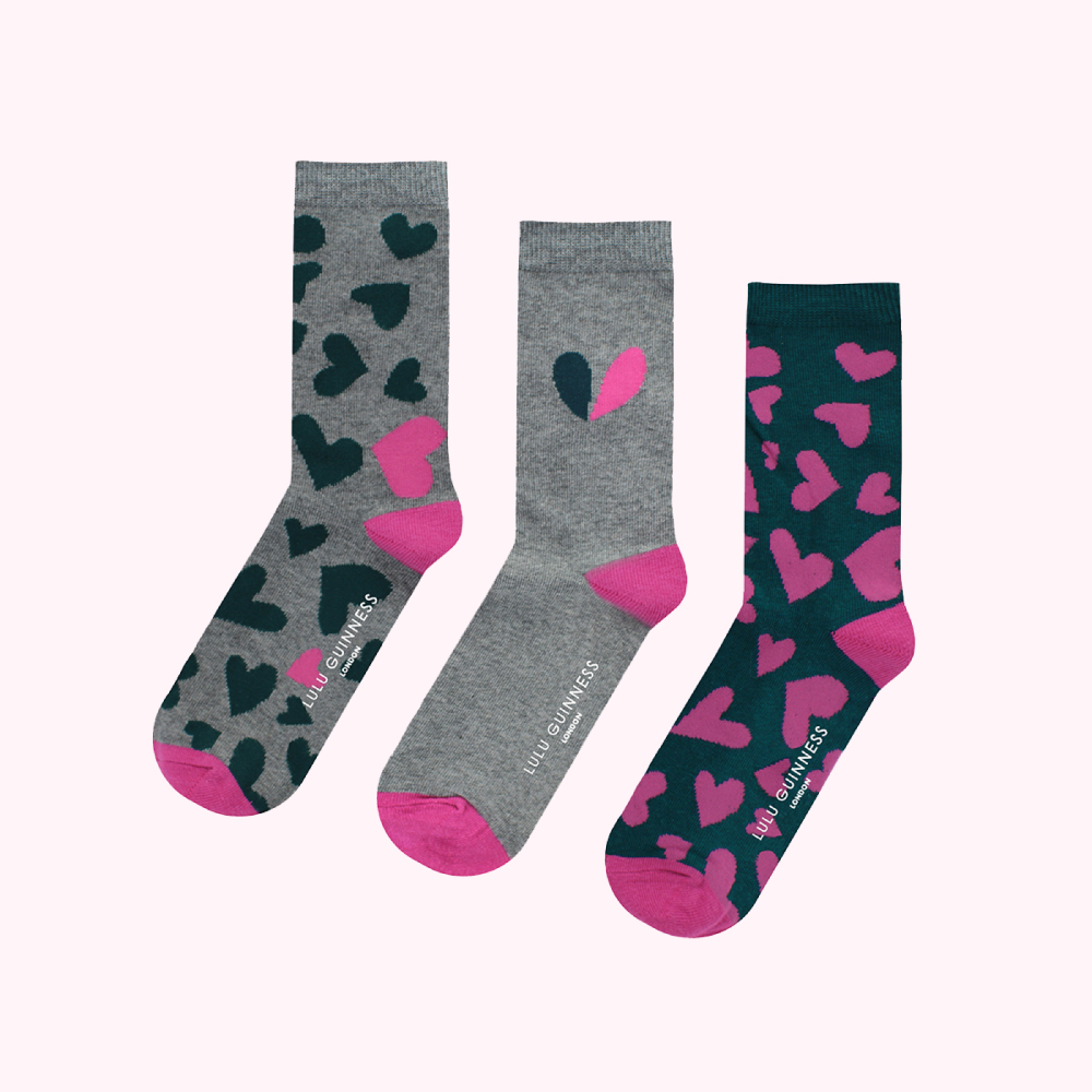 Three pairs of Lulu Guinness socks with heart patterns in teal, grey, and pink.