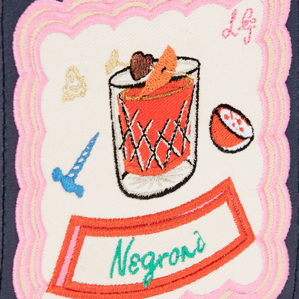 Embroidered patch on a navy background featuring a Negroni cocktail illustration with various design elements in pink, orange, green, and blue.