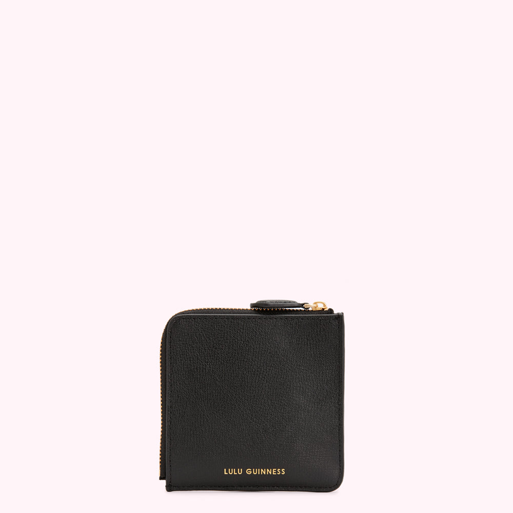 Black Lulu Guinness zip-around wallet against a white background.
