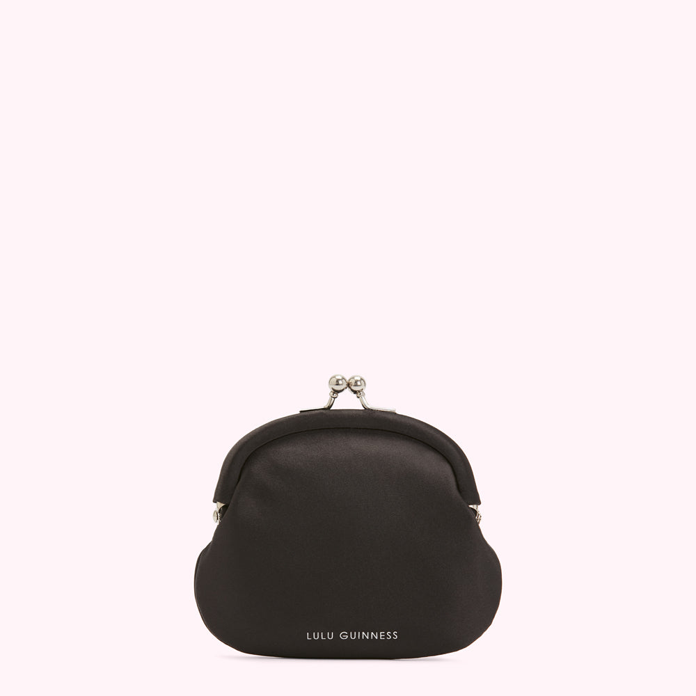 Black Lulu Guinness purse with silver clasp against a white background.
