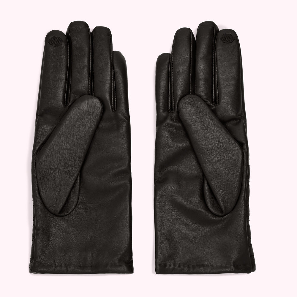 Pair of black leather gloves on a white background.