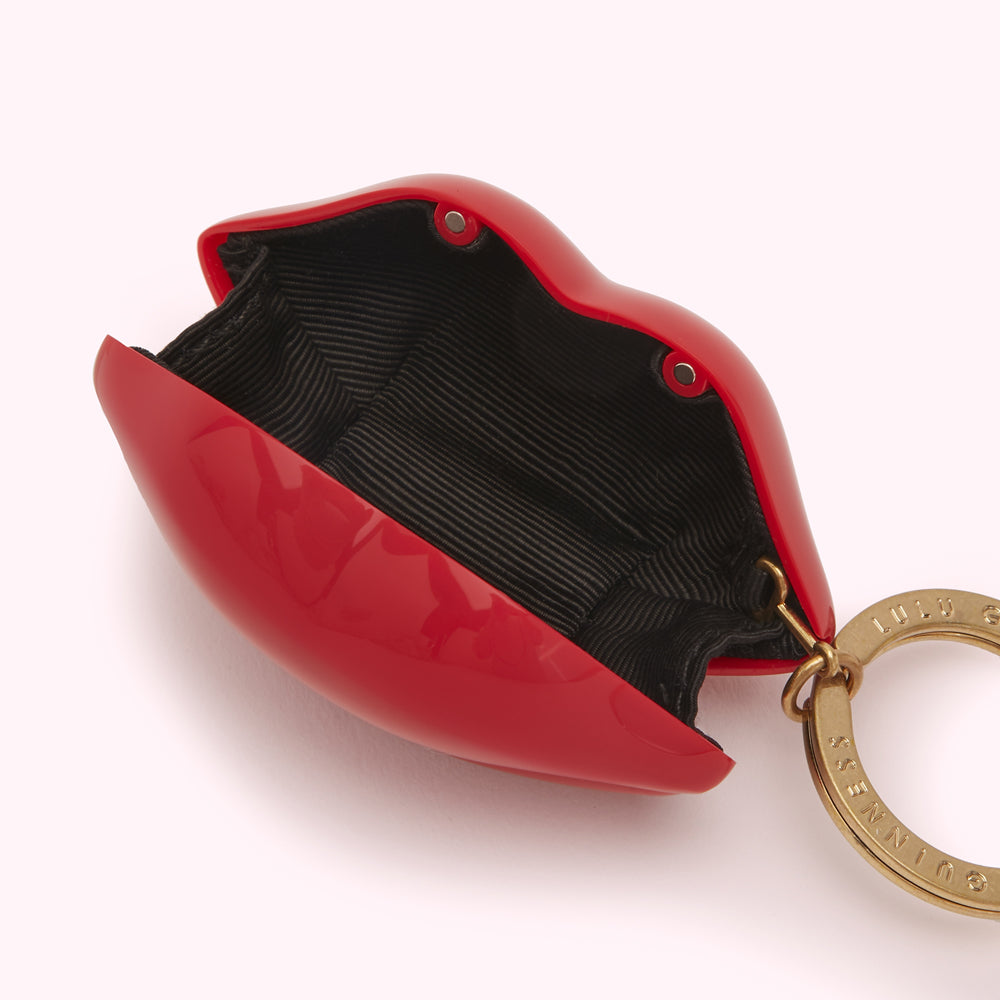 Red lip-shaped purse keychain with black interior and gold-toned hardware.