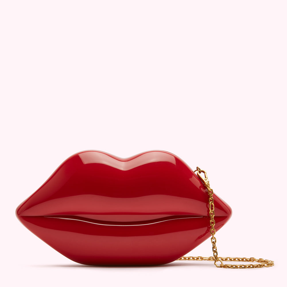 Red lip-shaped clutch with gold chain.