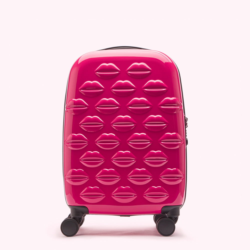 Pink suitcase with lip print design.
