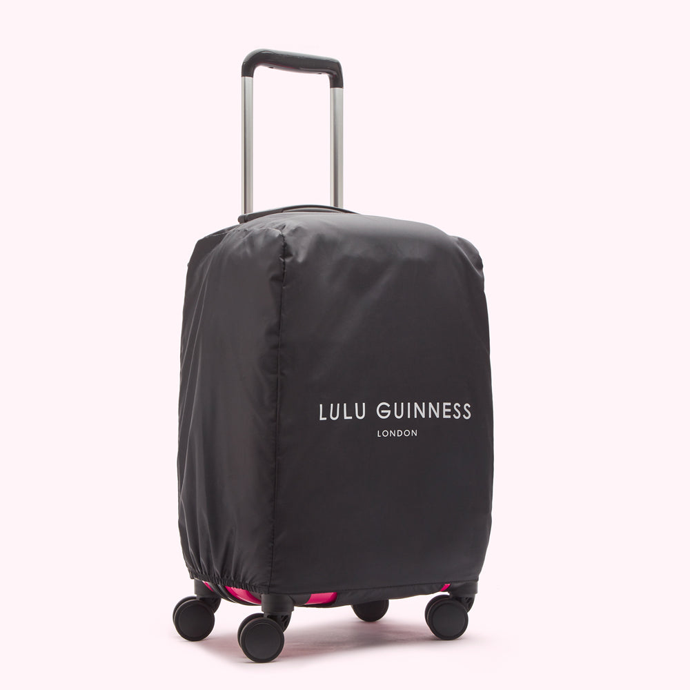 Black luggage cover with "Lulu Guinness London" logo on a pink suitcase.
