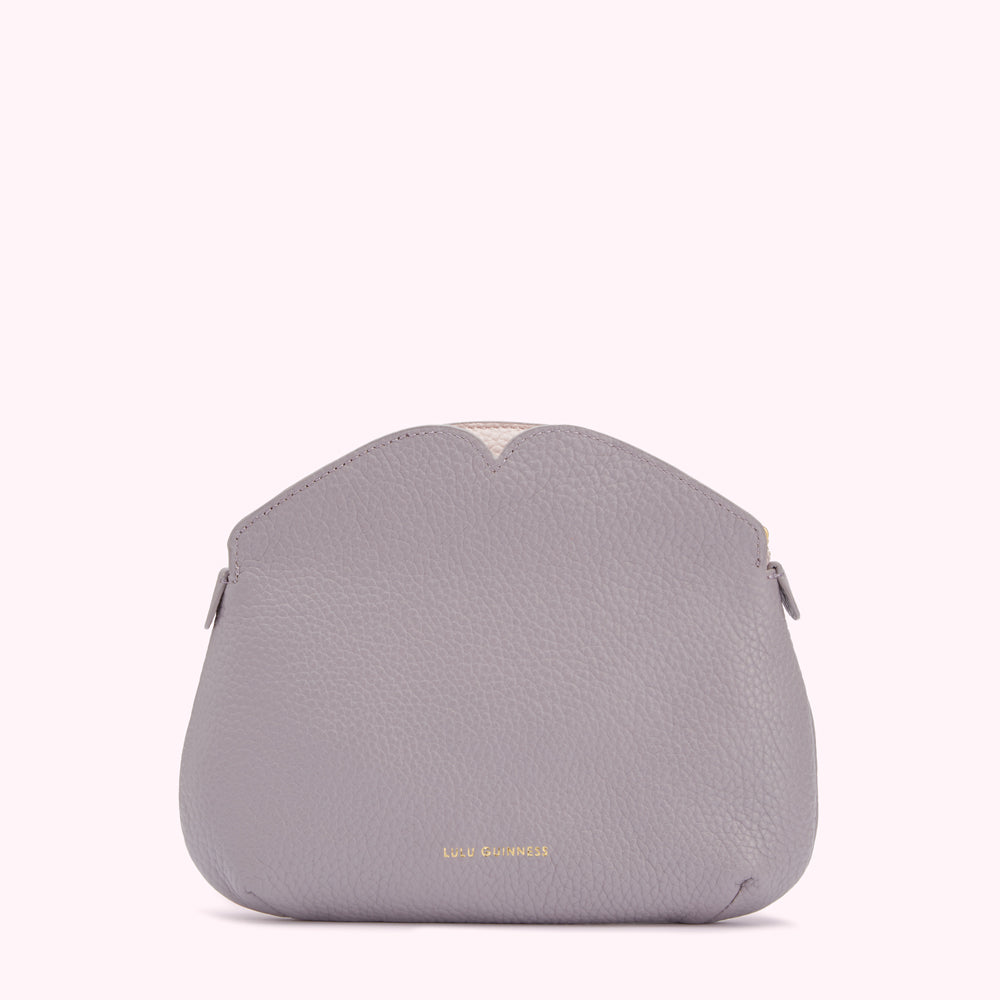 A grey Lulu Guinness purse with a heart-shaped top detail against a white background.