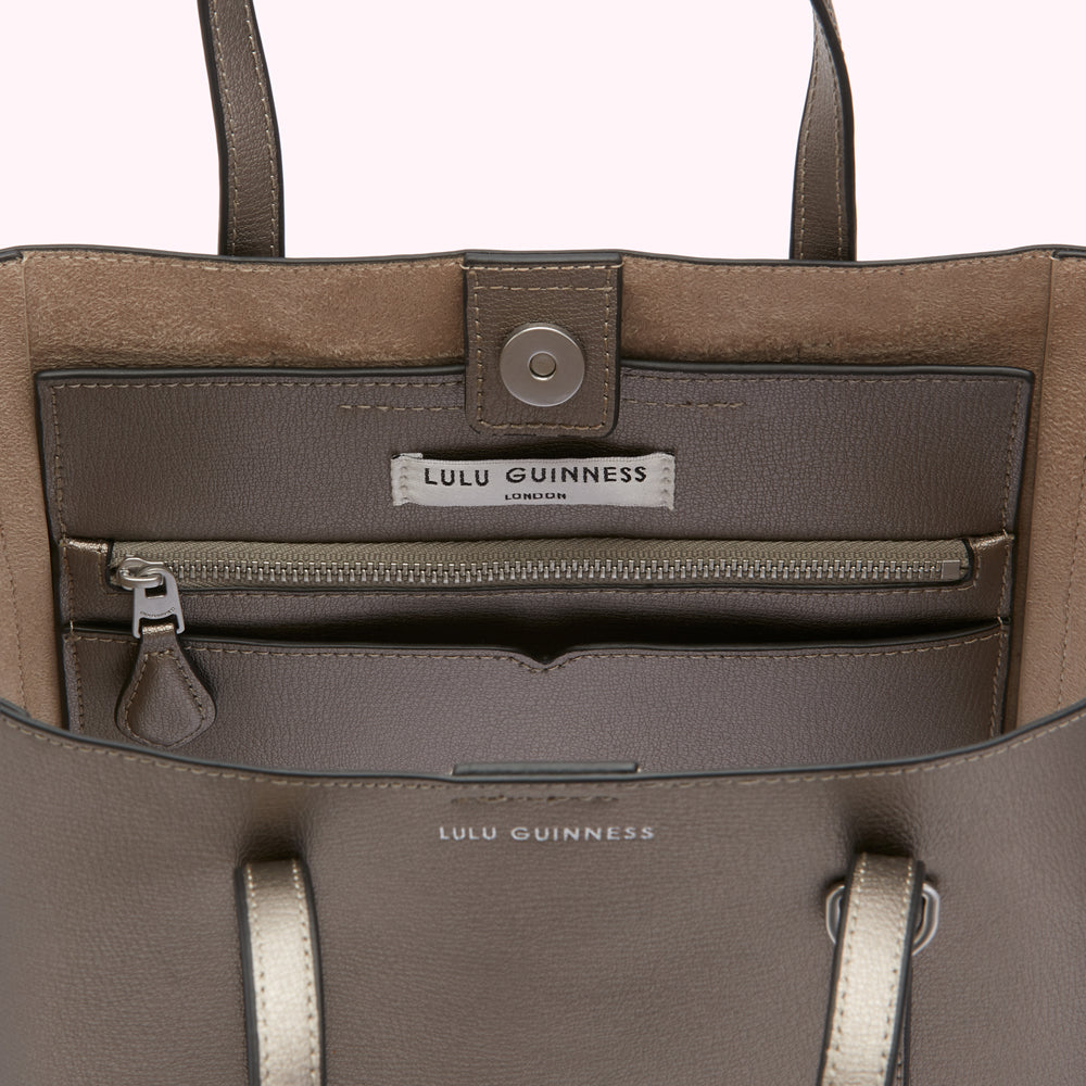 Inside of a taupe Lulu Guinness tote bag showing the interior pockets and branding.