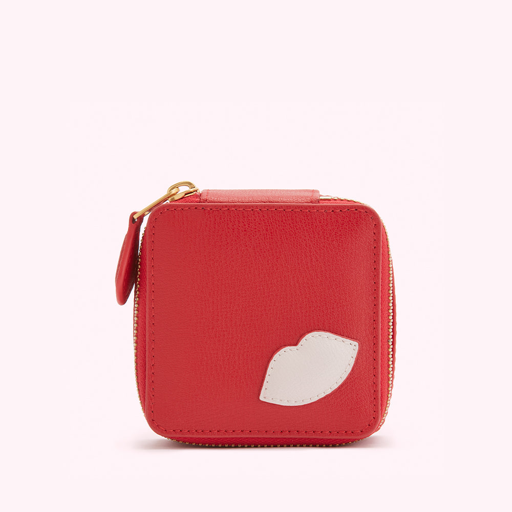 Red leather zippered pouch with a white lip design.