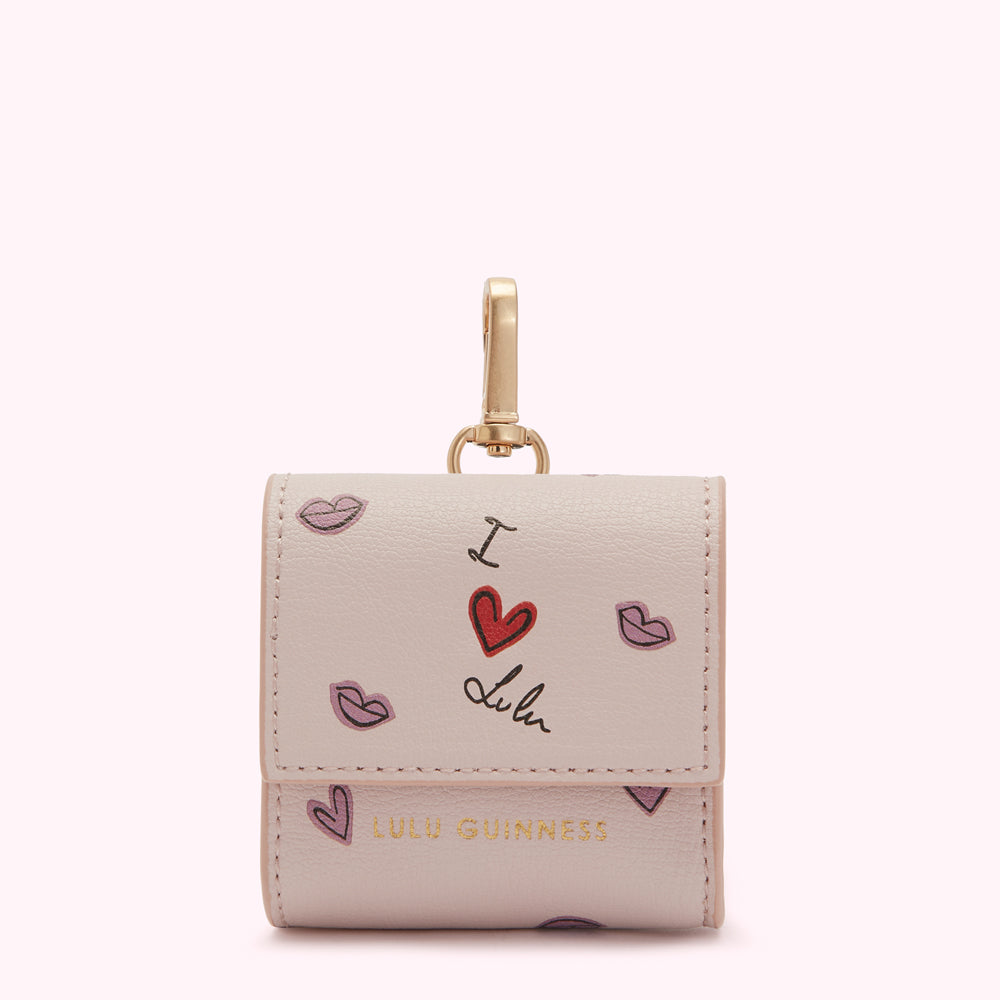 Light pink Lulu Guinness Air pods case with gold clasp, adorned with a "I love Lulu" design and pink lip prints.
