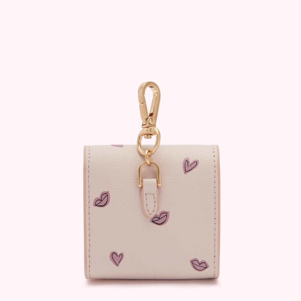 Beige leather keychain with pink lips and hearts pattern.