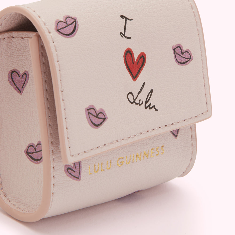 Close-up of a light beige Lulu Guinness AirPods case with a pattern of hearts and lips, and the text "I love Lulu" in handwritten style.