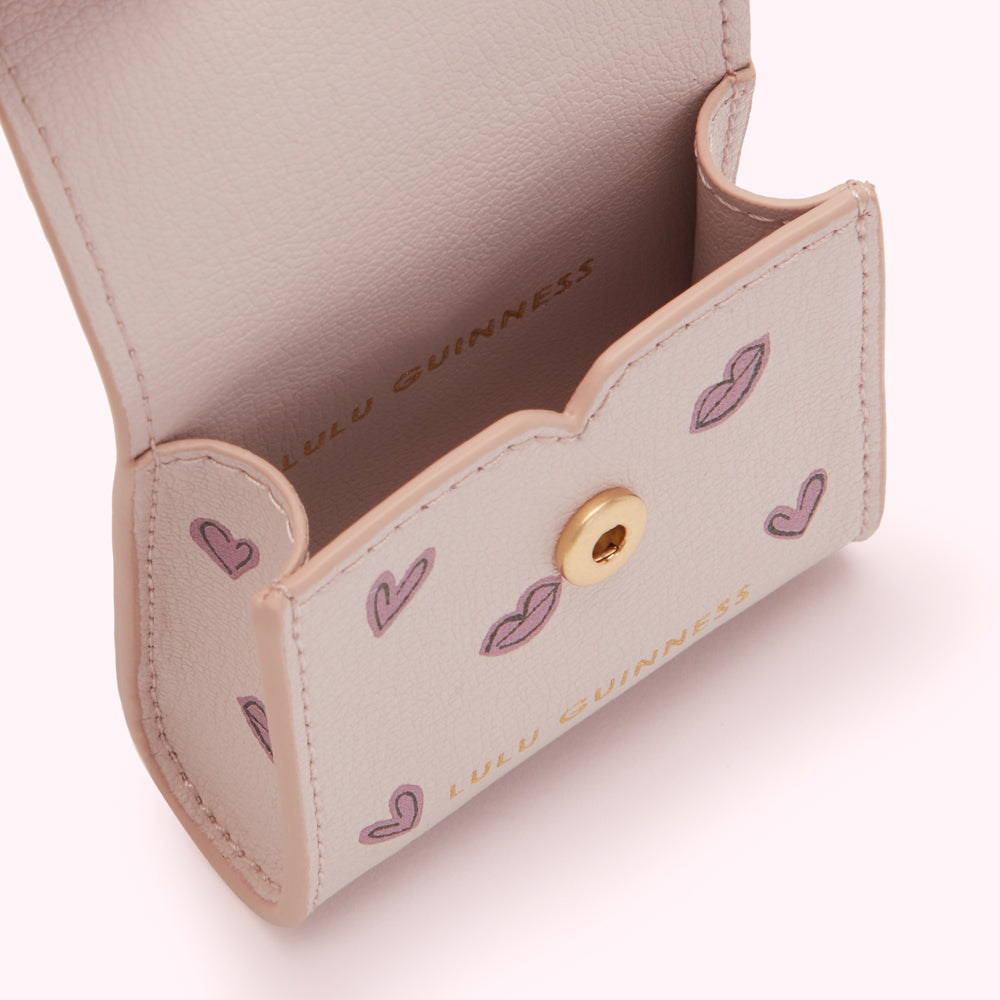 Close-up of a pale pink Lulu Guinness cardholder with a pattern of hearts and lips; the interior is visible.