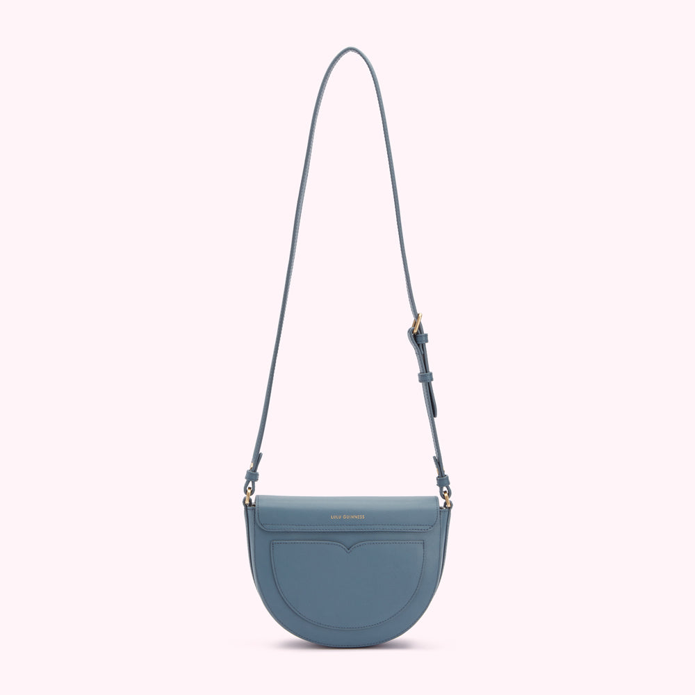 Dusty blue half-moon crossbody bag by Lulu Guinness.
