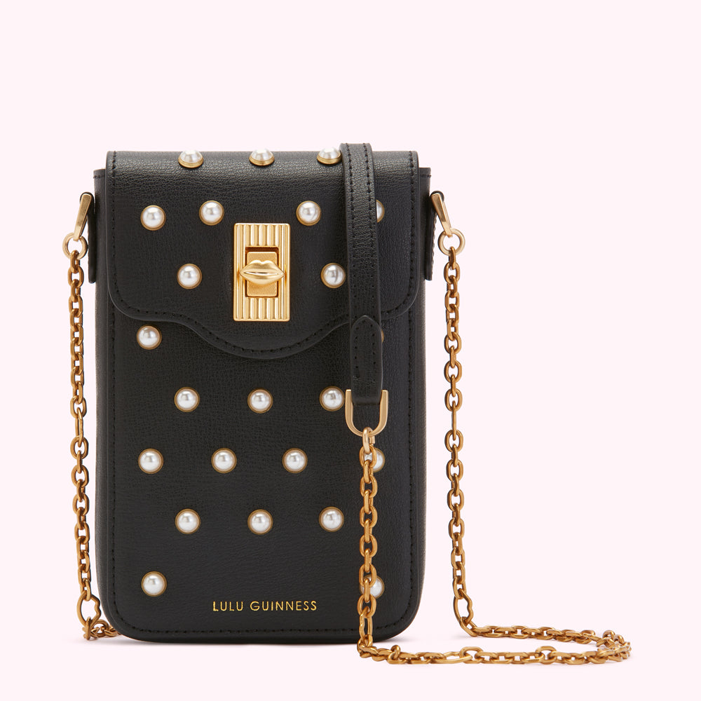 Black Lulu Guinness crossbody bag with gold chain strap and pearl embellishments.