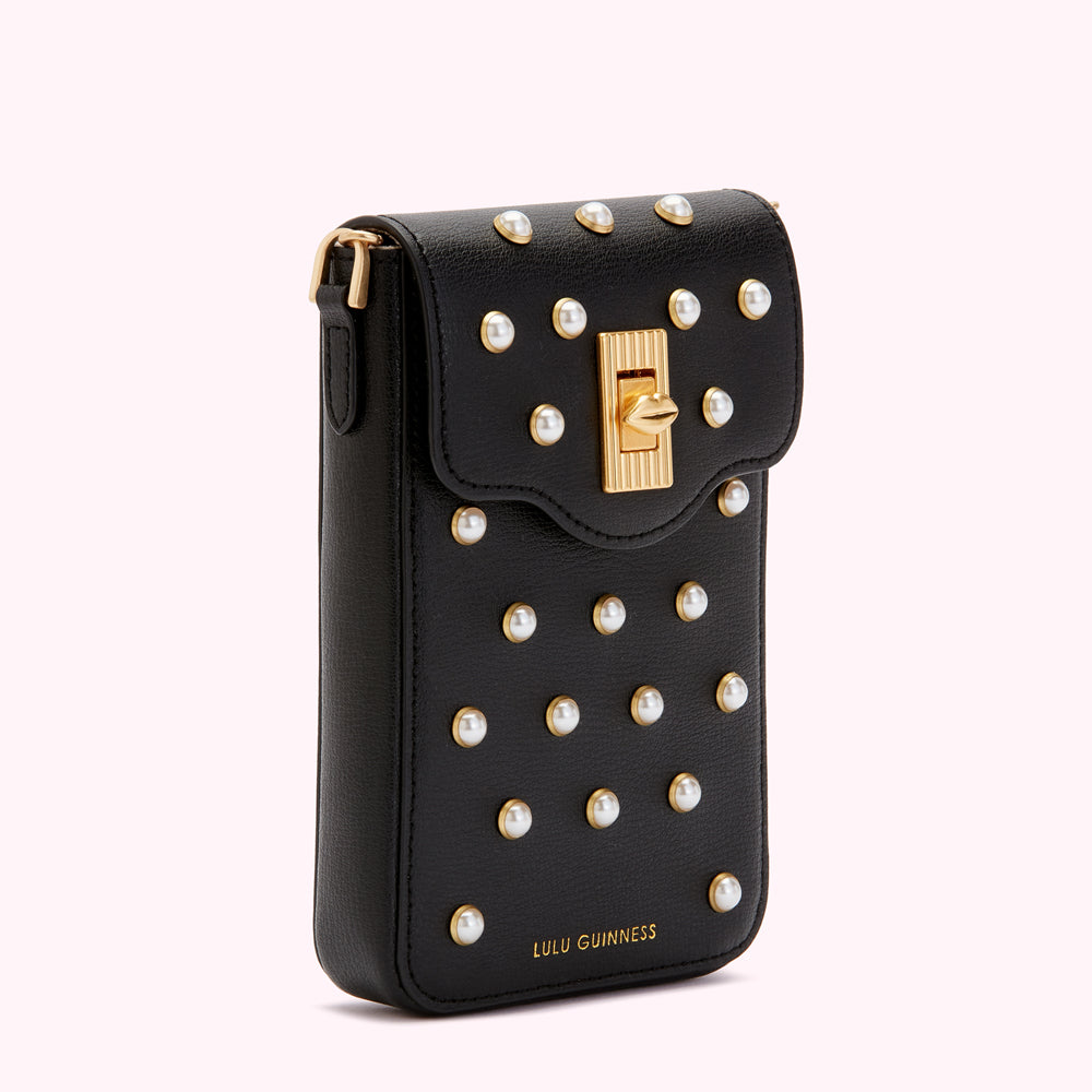 Black Lulu Guinness crossbody bag adorned with pearl detailing and gold accents.
