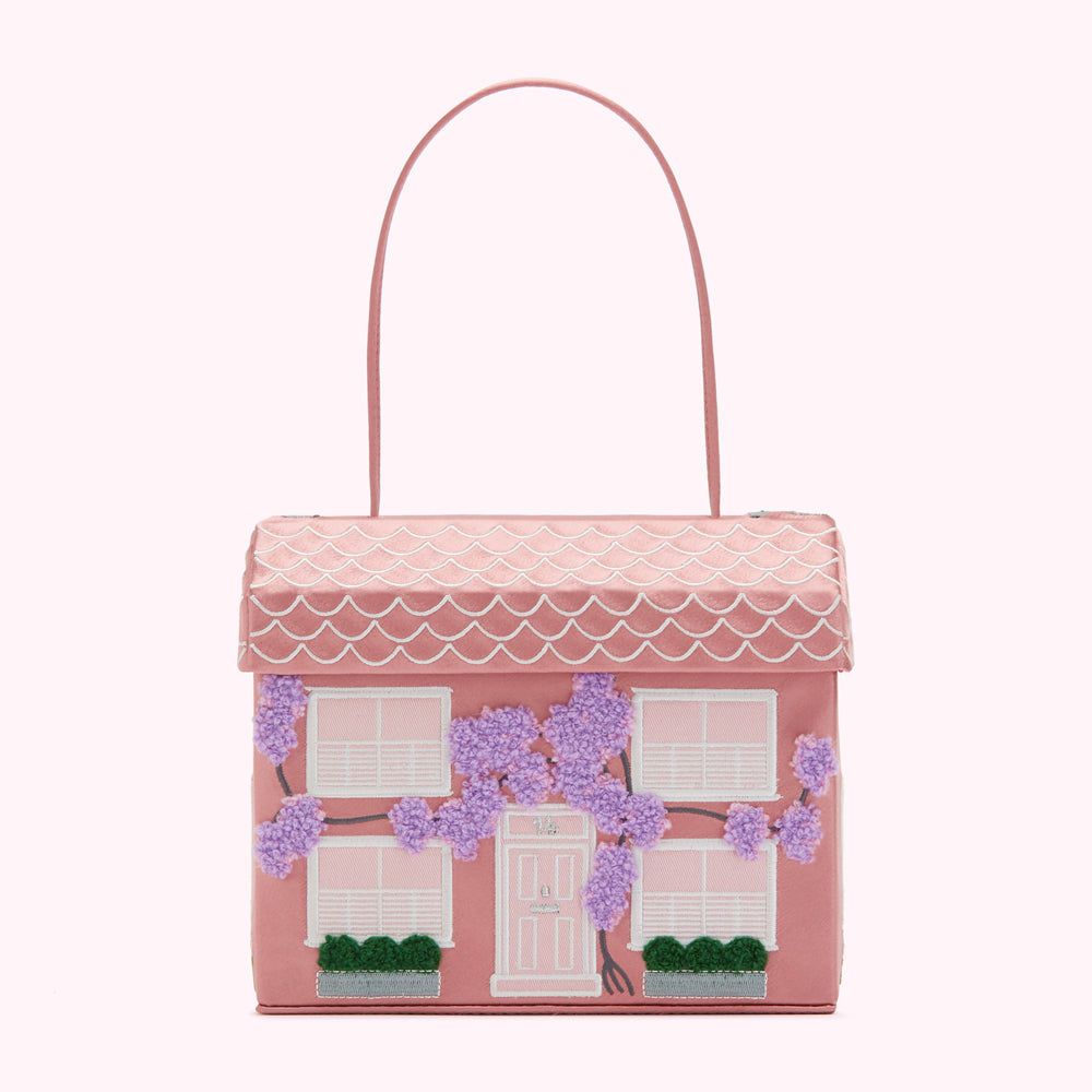 Pink house-shaped handbag with lavender wisteria embroidery.